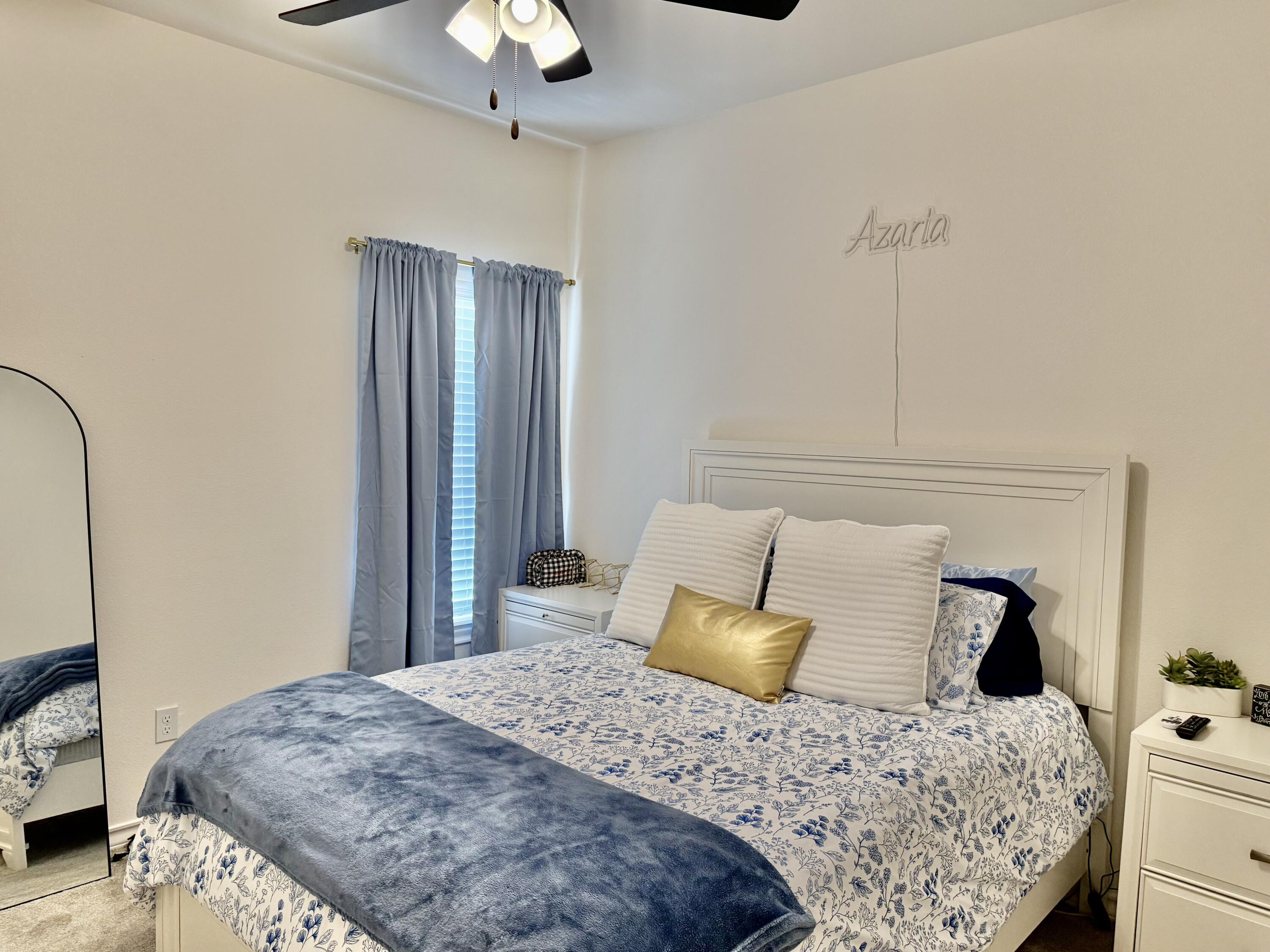 5833 Virginia Avenue Lubbock, TX 79407 - Photo 11 of 33 a bedroom with a bed and wooden floor