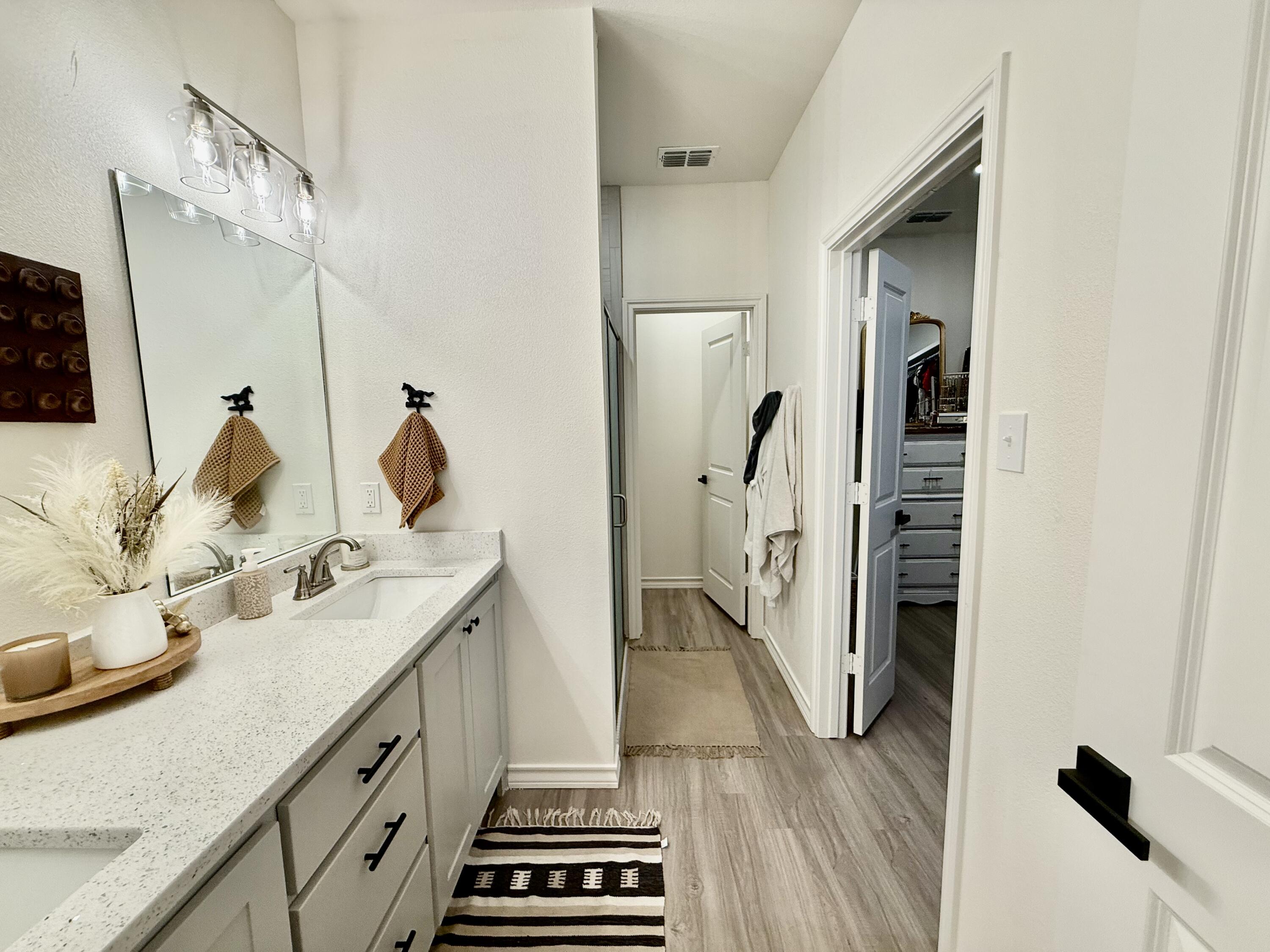5833 Virginia Avenue Lubbock, TX 79407 - Photo 15 of 33 a bathroom with double vanity and a bathtub
