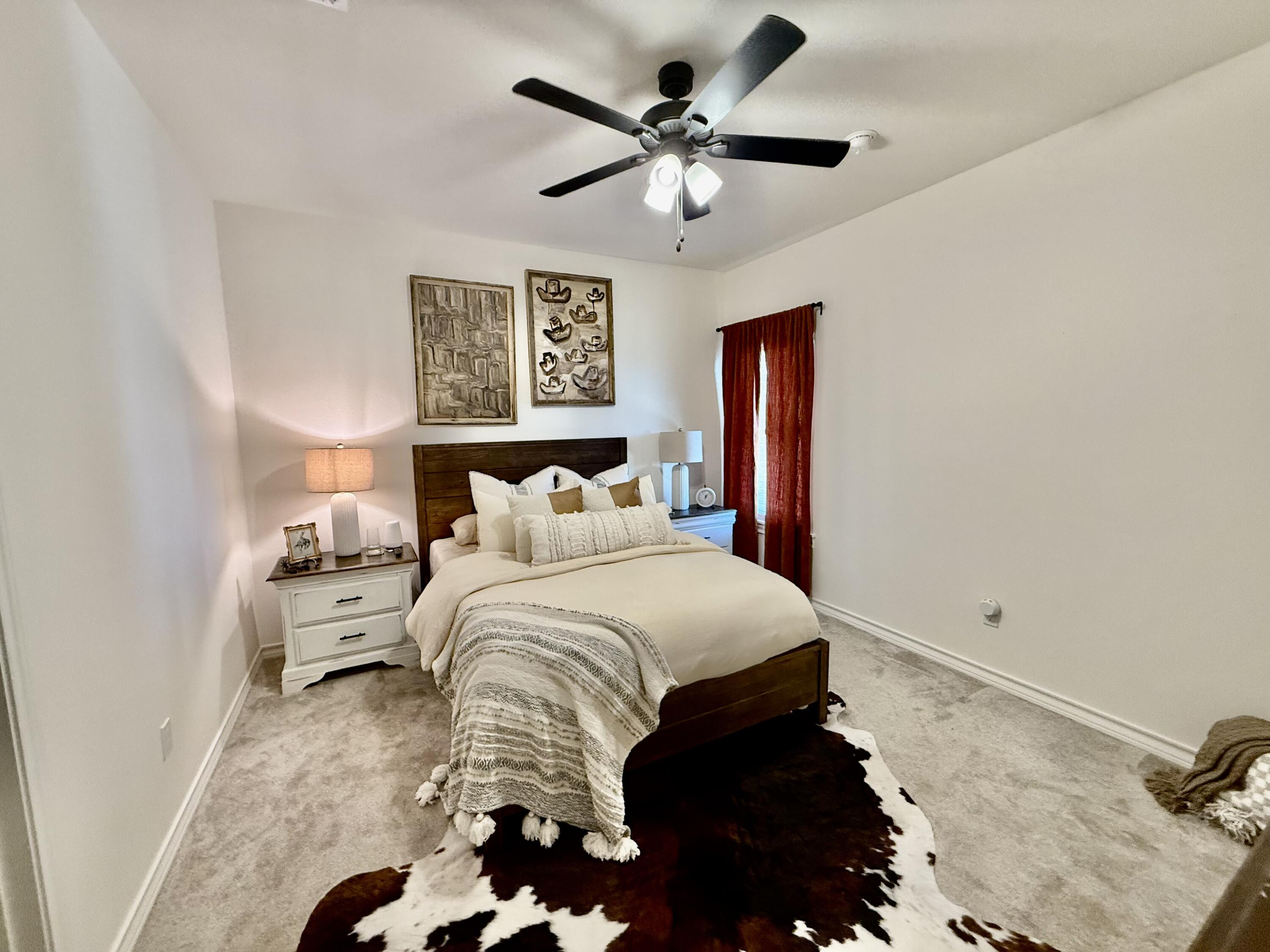 5833 Virginia Avenue Lubbock, TX 79407 - Photo 18 of 33 a bedroom with a bed and a chandelier