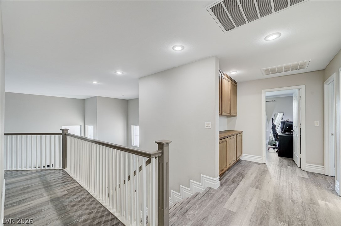 2391 Rainswept Avenue Henderson, NV 89052 - Photo 41 of 62 This bright hallway connects various living spaces with stylish flooring and practical built-ins.