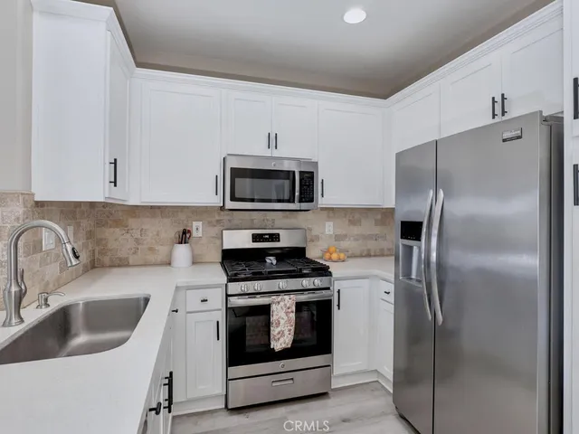 a kitchen with a sink and a refrigerator