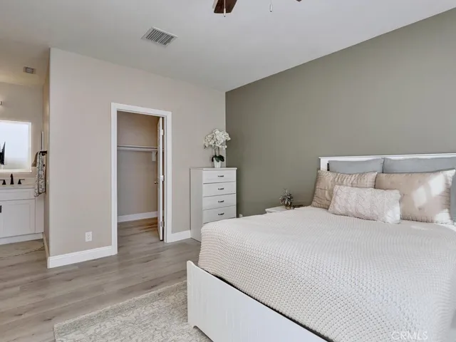 a bathroom with a granite countertop sink vanity and mirror