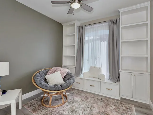 a living room with furniture a rug and a painting