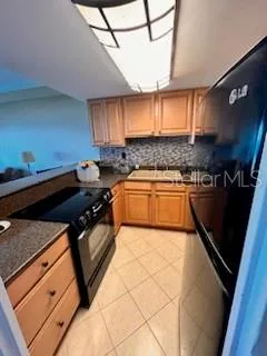 a kitchen with a sink appliances and cabinets