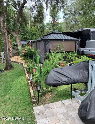 a view of backyard with patio