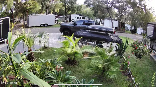 a view of a patio with table and chairs and potted plants