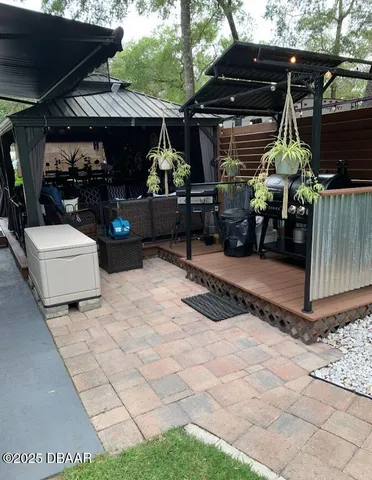 a view of a patio with couches table and chairs and potted plants