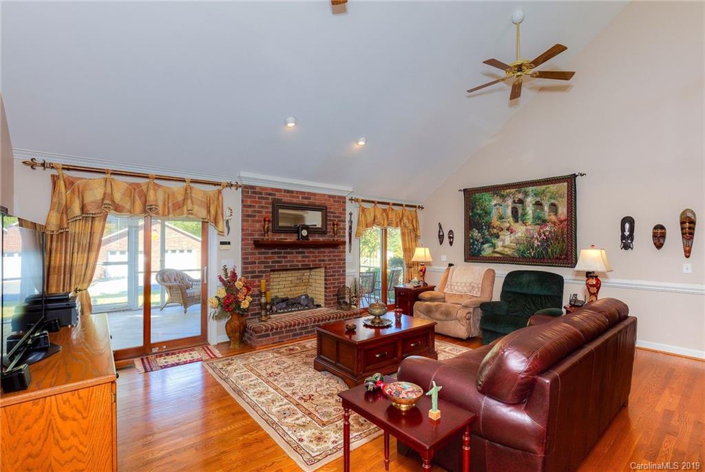 34863 Finger Road Mount Pleasant, NC 28124 - Photo 11 of 32 a living room with furniture a fireplace and a floor to ceiling window