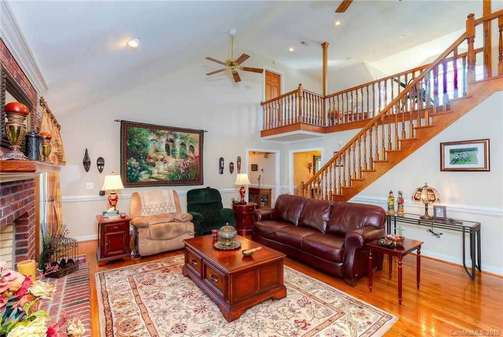 34863 Finger Road Mount Pleasant, NC 28124 - Photo 12 of 32 a living room with furniture a rug and a book shelf
