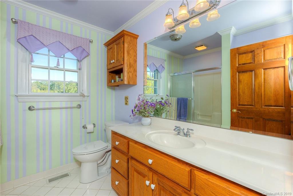 34863 Finger Road Mount Pleasant, NC 28124 - Photo 15 of 32 a bathroom with a sink a toilet and a large mirror