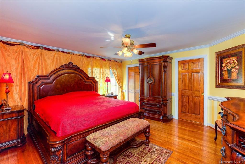 34863 Finger Road Mount Pleasant, NC 28124 - Photo 17 of 32 a bedroom with a bed and a chandelier