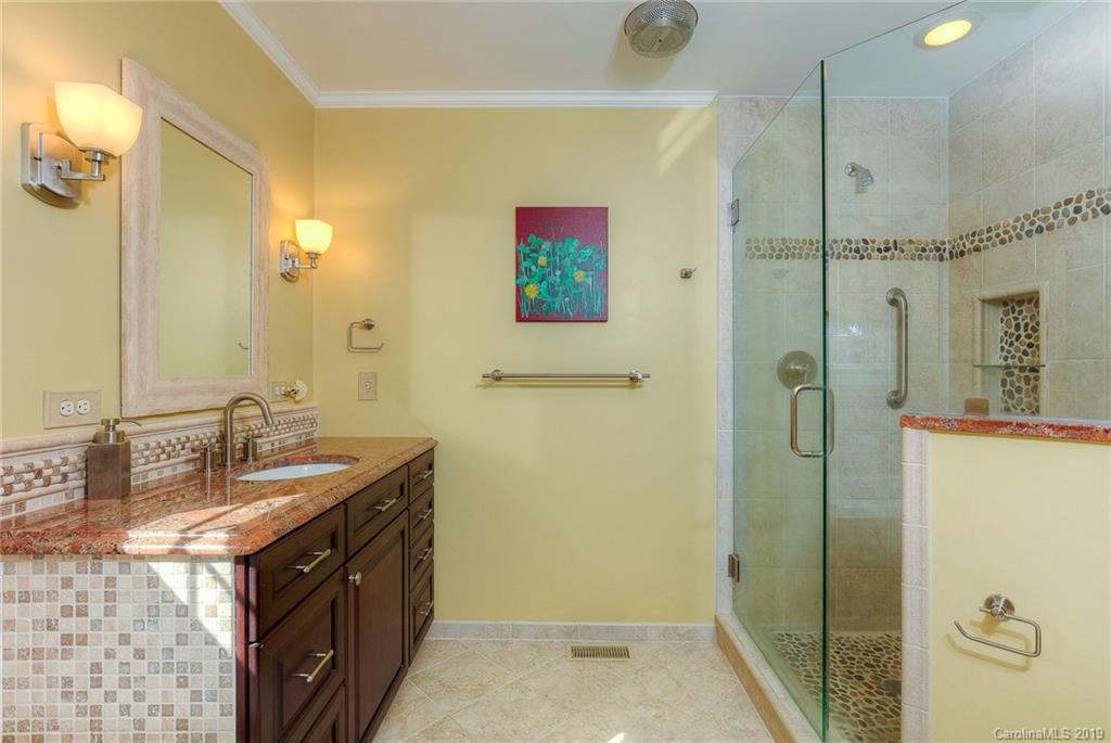 34863 Finger Road Mount Pleasant, NC 28124 - Photo 19 of 32 a bathroom with a granite countertop sink a mirror a shower and vanity