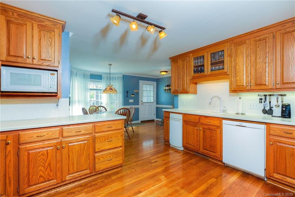 34863 Finger Road Mount Pleasant, NC 28124 - Photo 7 of 32 a large kitchen with stainless steel appliances granite countertop wooden cabinets a sink and dishwasher a stove with wooden floor