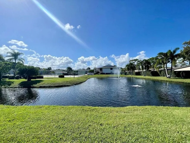 a view of a lake with a house in the background