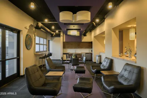 a media room with lots of chairs and a chandelier