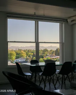 a view of a city from a dining room with large windows