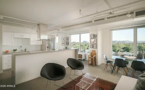 a kitchen with a table chairs stove and cabinets
