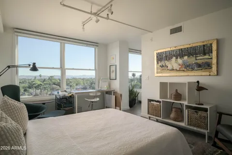 a bedroom with a large bed and a window