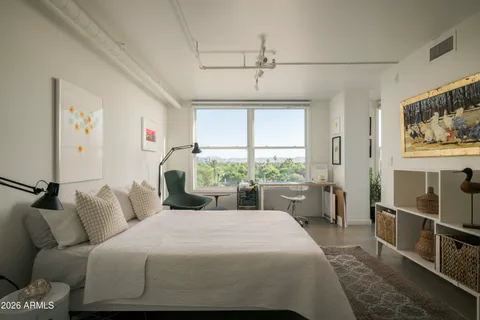 a bedroom with a large bed and a window