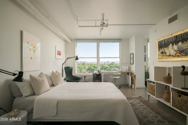 a bedroom with a large bed and a window