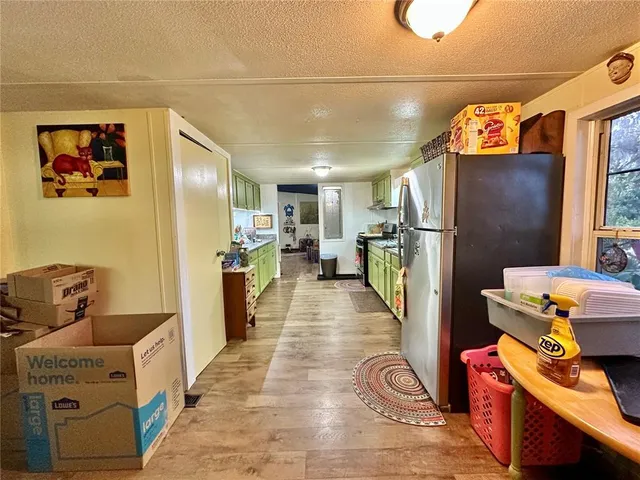 a hallway with a white stove top oven and refrigerator