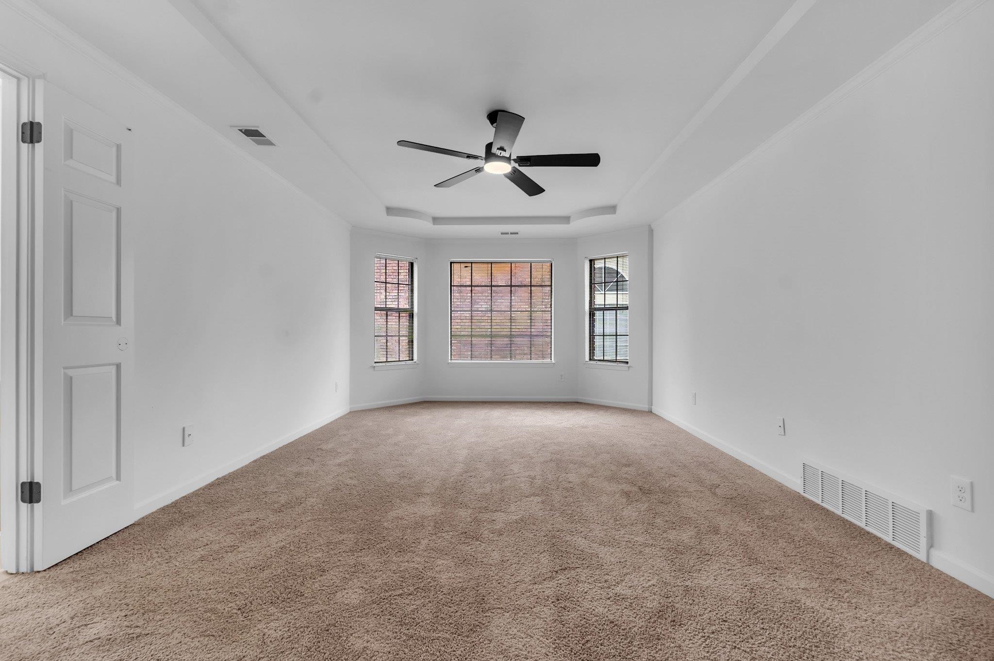 6613 Stephan Ridge Drive Bartlett, TN 38135 - Photo 16 of 24 Expansive room with neutral carpet, tray ceiling, and a multi-pane bay window