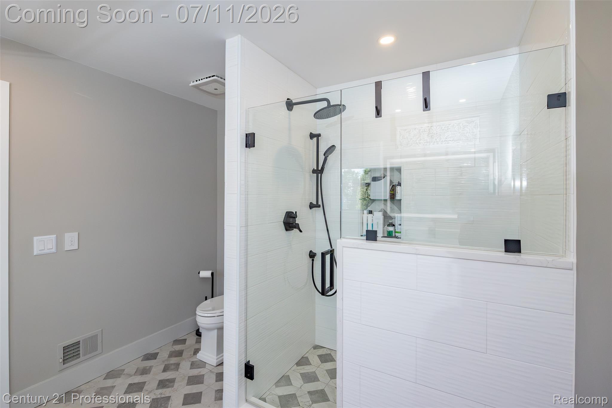 689 Woodfield Way Rochester, MI 48307 - Photo 12 of 61 Contemporary bathroom featuring a spacious glass-enclosed shower with matte black fixtures, a built-in shower niche, and white subway tile