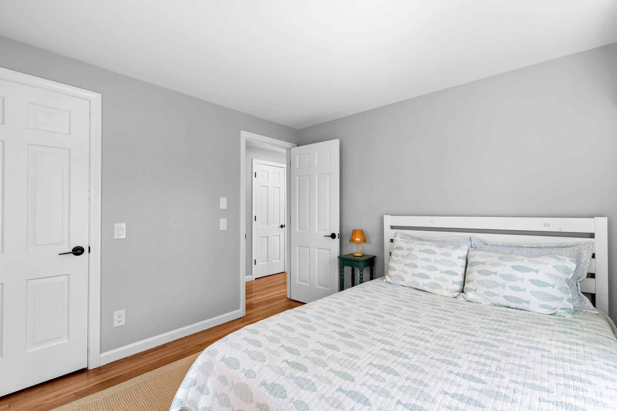 1295 Massasoit Road Eastham, MA 02642 - Photo 20 of 32 a bedroom with a bed and wooden floor
