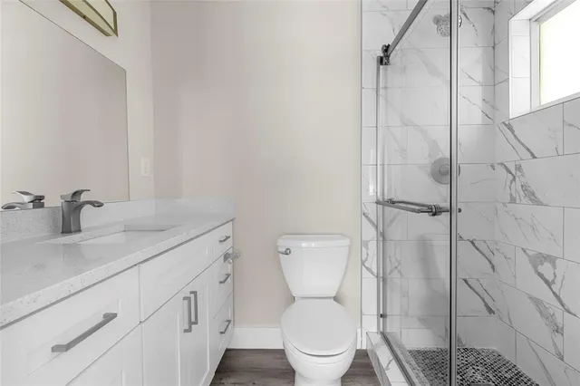 a white toilet sitting next to a bathroom sink