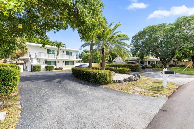 a view of a house with garden and trees