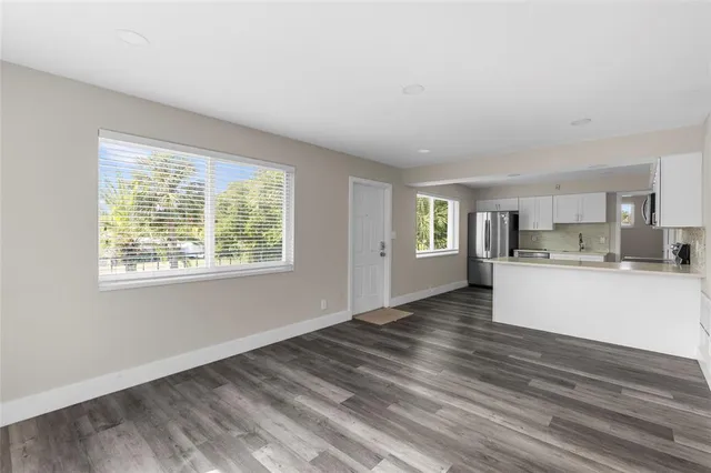 a view of kitchen and hall with wooden floor