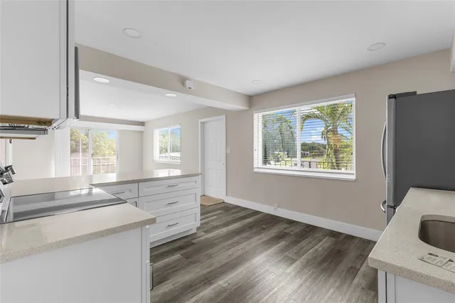 a view of a kitchen cabinets a sink and wooden floor