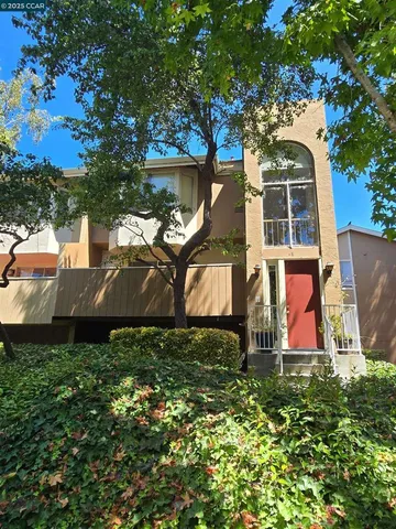 an aerial view of a house with swimming pool and garden