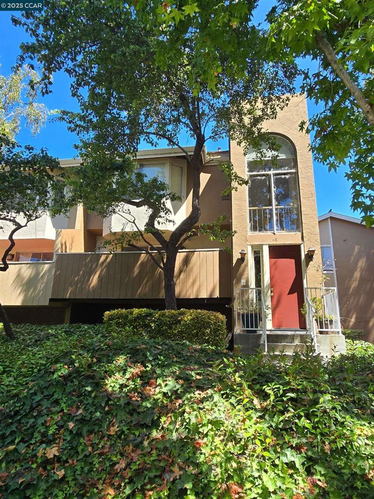an aerial view of a house with swimming pool and garden