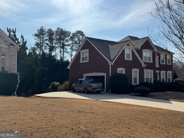 a front view of a house with a yard