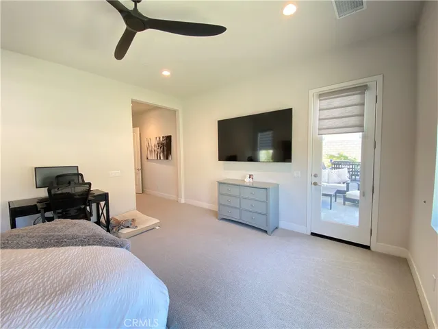 a bedroom with a bed and a painting on the wall