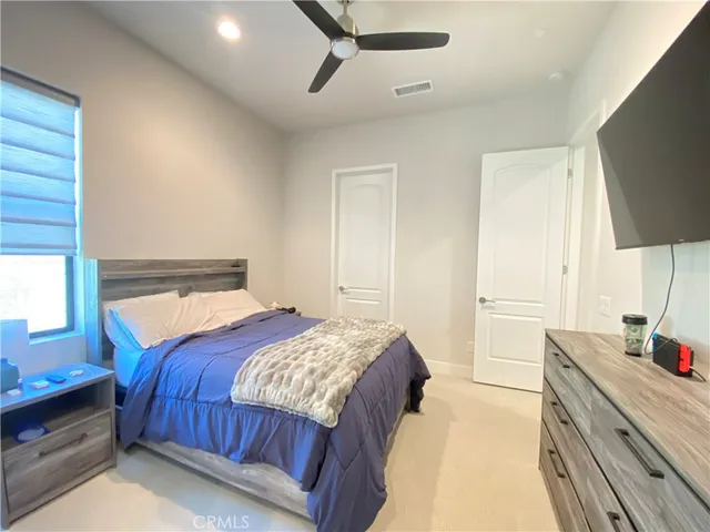 a bedroom with a bed and dresser