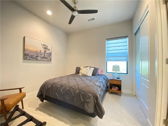 a living room with furniture a large window and a flat screen tv