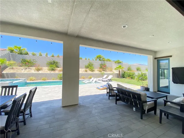a view of a terrace with a garden and seating area