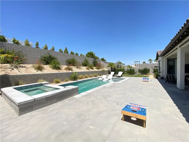 a view of a house with swimming pool and a chairs