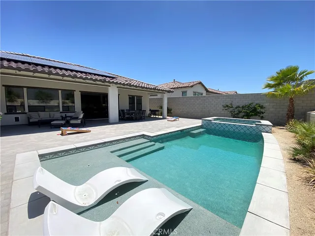 a front view of a house with a yard and outdoor seating