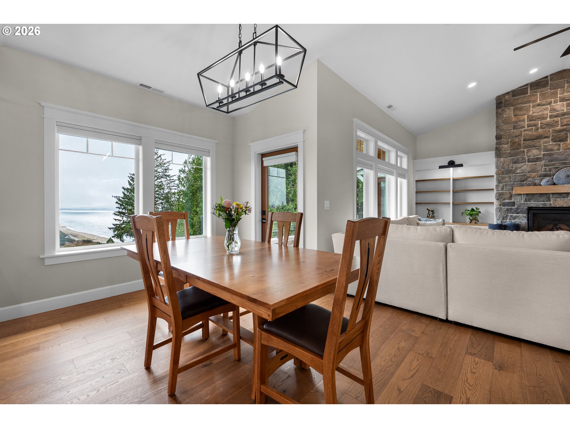 38590 Meadow Loop Nehalem, OR 97131 - Photo 11 of 48 a dining room with furniture a chandelier and wooden floor