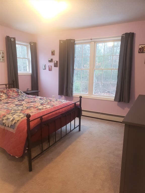 174 Old Belchertown Road Ware, MA 01082 - Photo 22 of 42 a bed sitting in a spacious bedroom next to a window