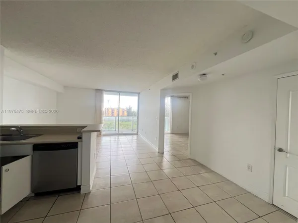a spacious bathroom with a granite countertop sink a toilet and a mirror
