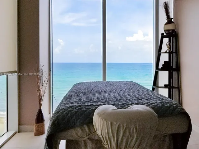 a bedroom with a bed next to a window