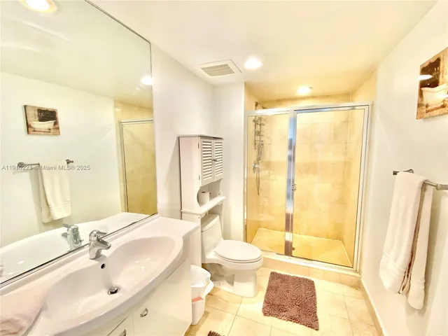a bathroom with a bathtub shower sink and a toilet