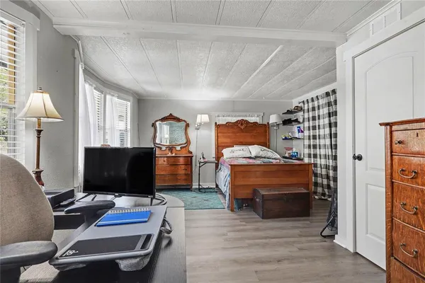 a bedroom with furniture and a window