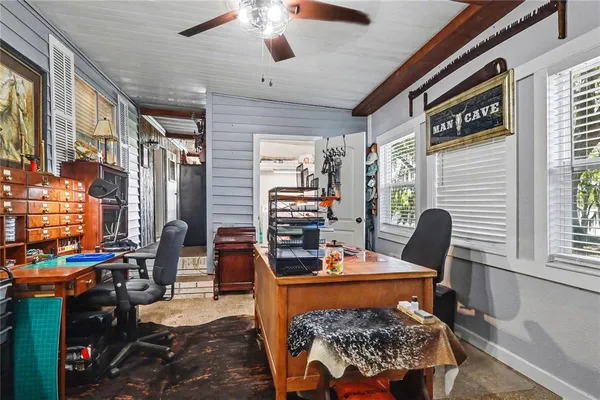 a view of a workspace with furniture and a window