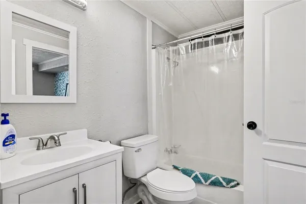 a white toilet sitting next to a bathroom sink