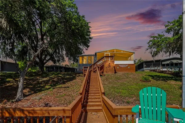 a view of a swimming pool with a patio and a yard